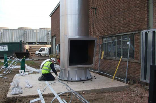 Steel Chimney inspection, man on his knees in high vis vest