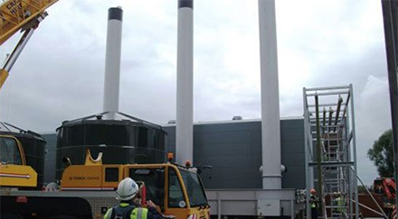 3 white chimneys with black tops