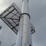 Steel platform attached to large steel chimney