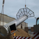 crane lifting steel chimney with platform