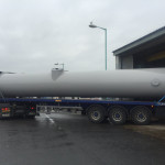 Section of steel chimney on the back of a flat bed truck