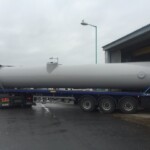 Section of steel chimney on the back of a flat bed truck